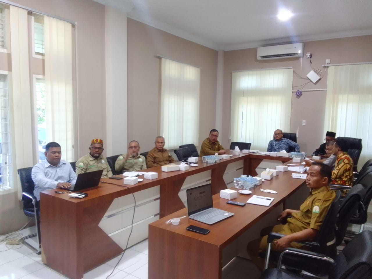 3D rendering of modern high-rise building with glass façade and complex geometric shapes